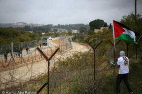 Army arrive as protesters cut down Apartheid Wall. Photo by Hamdi Abu Rahma 