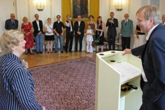 Staatssekretär Hubert Wicker (rechts) hält im Runden Saal der Villa Reitzenstein die Laudatio für Felicia-Amalia Langer (links).